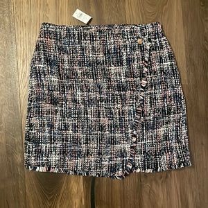 Tweed skirt with asymmetrical detail and gold button